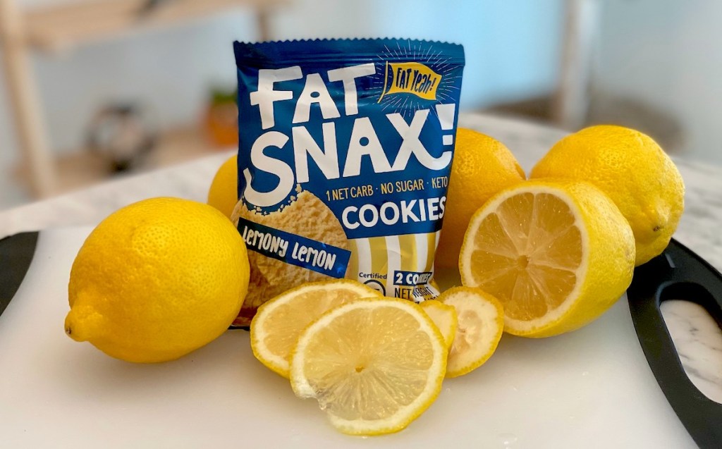 fat snax lemon cookie in bag surrounded by fresh lemons