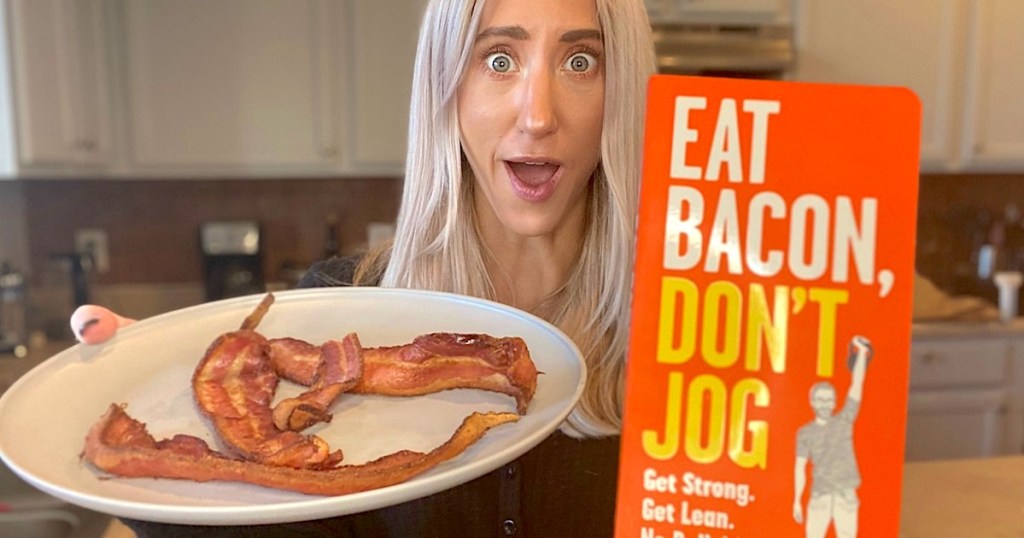 woman holding eat bacon dont jog book with white plate of bacon