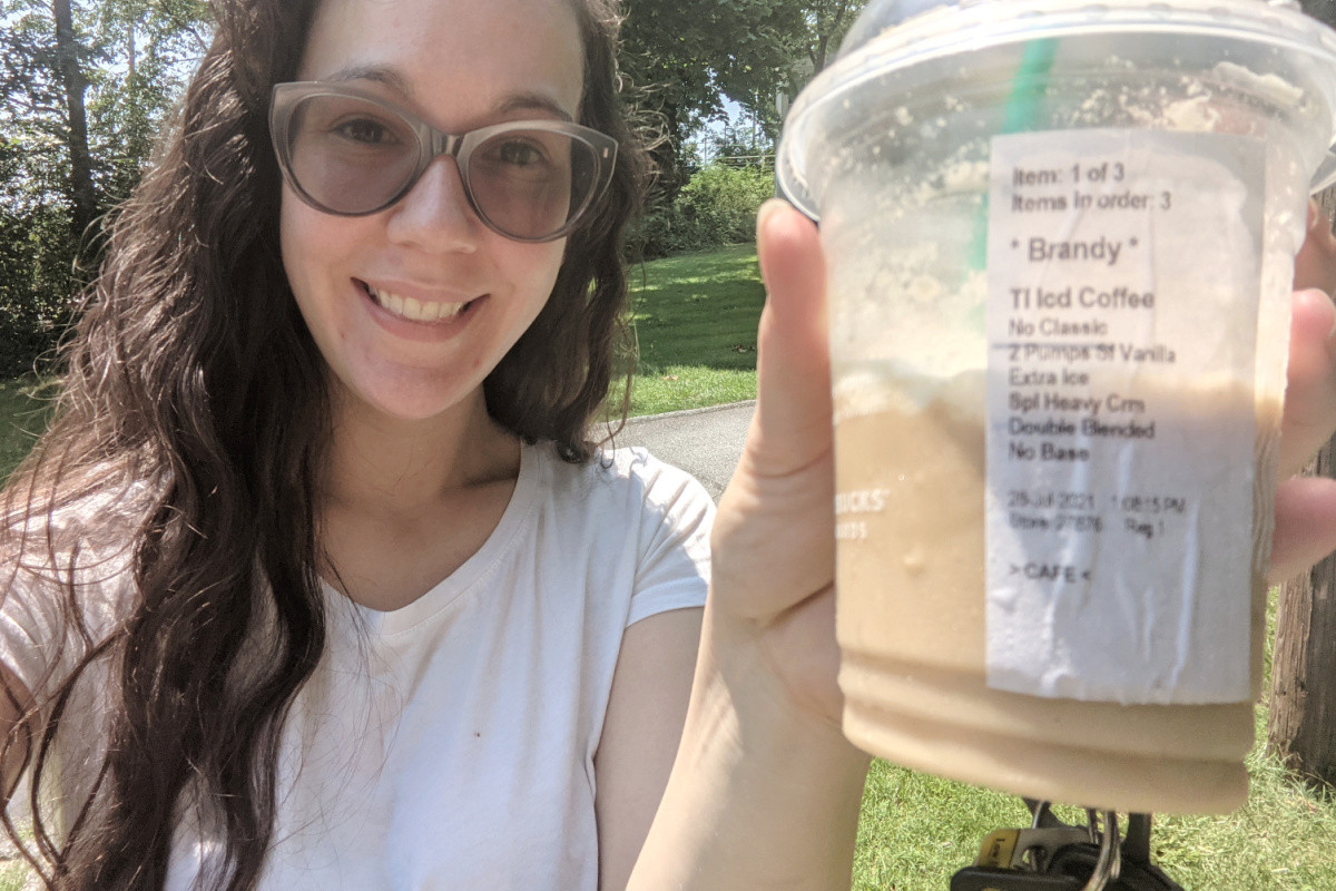 Woman holding keto frappuccino outside