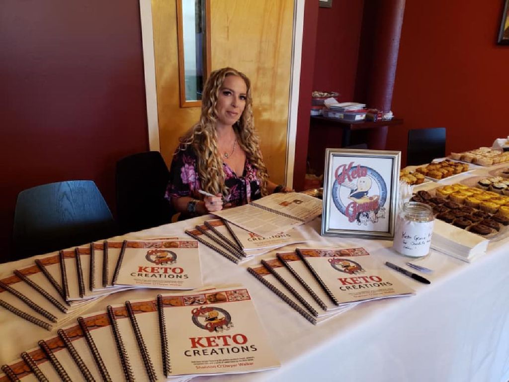 woman autographing cookbook