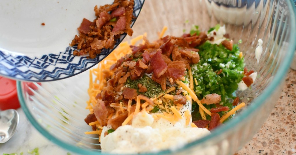 mixing up a keto bacon cheddar pine cone cheeseball