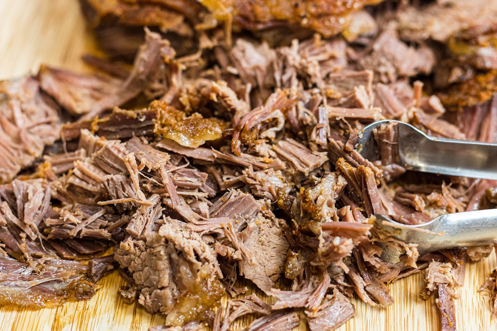 cutting board with shredded keto brisket