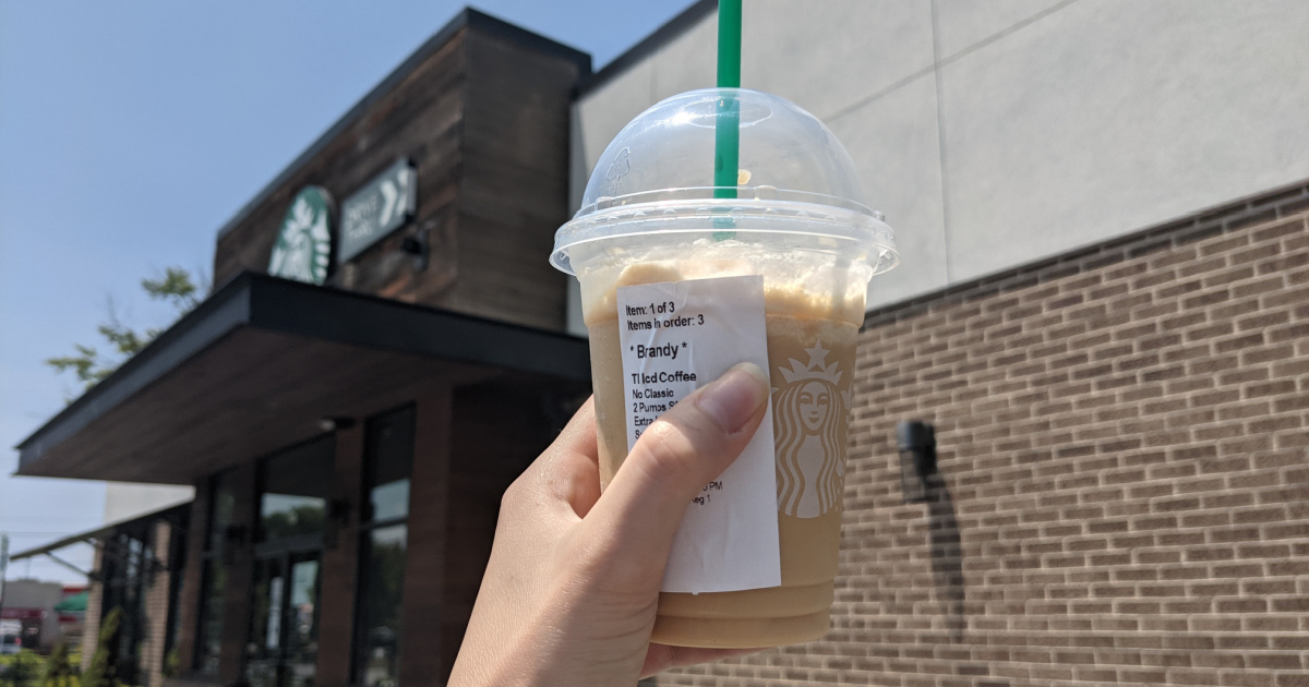 hand holding keto frappuccino in front of Starbucks
