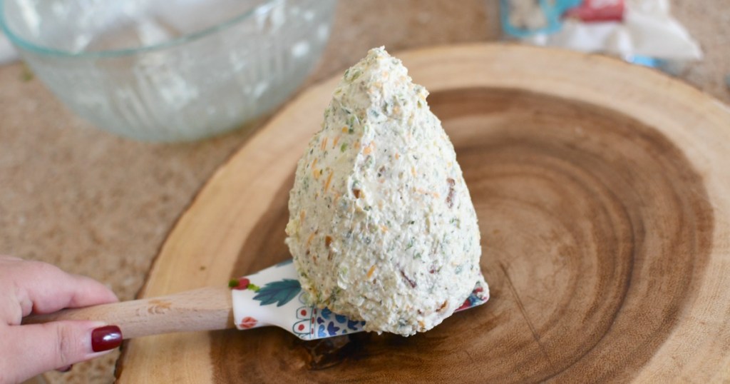 transferring cheeseball to platter for serving