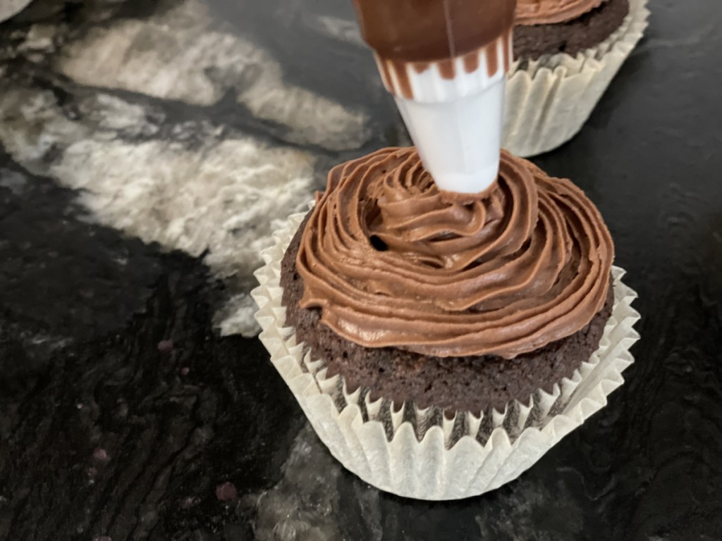 chocolate keto buttercream frosting a cupcake 