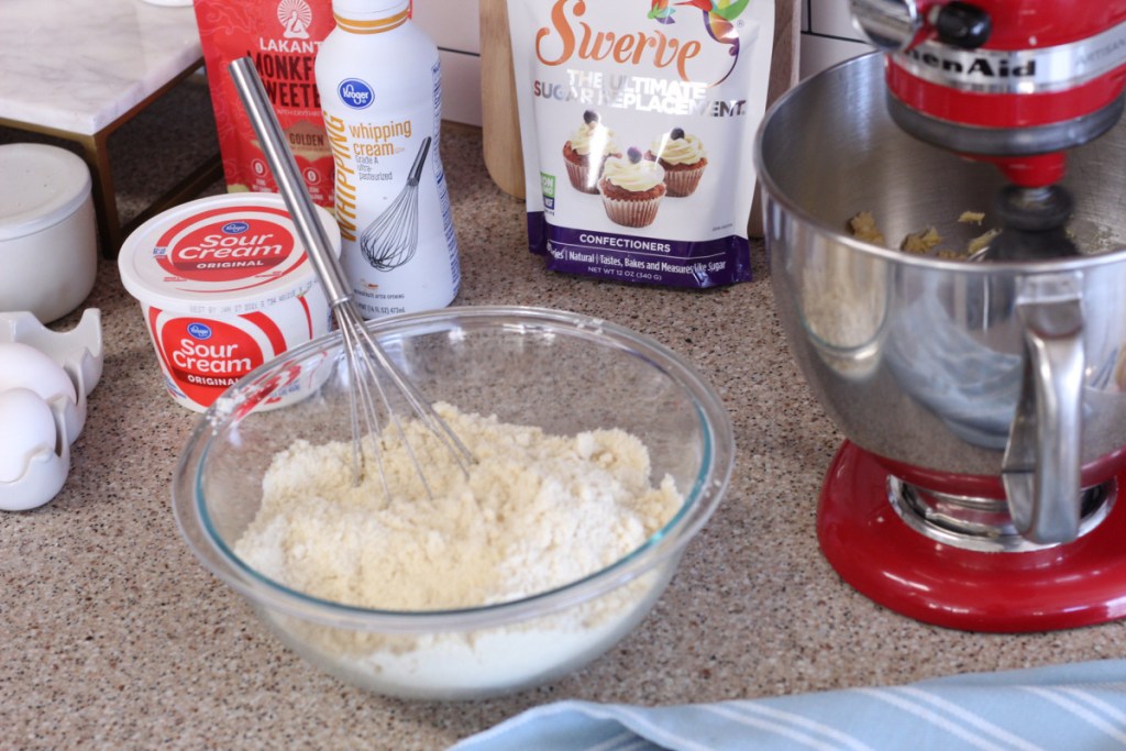 mixer and bowl of ingredients on the counter for keto sheet cake