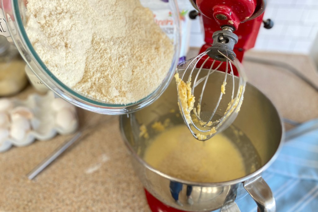 pouring dry ingredients into mixer