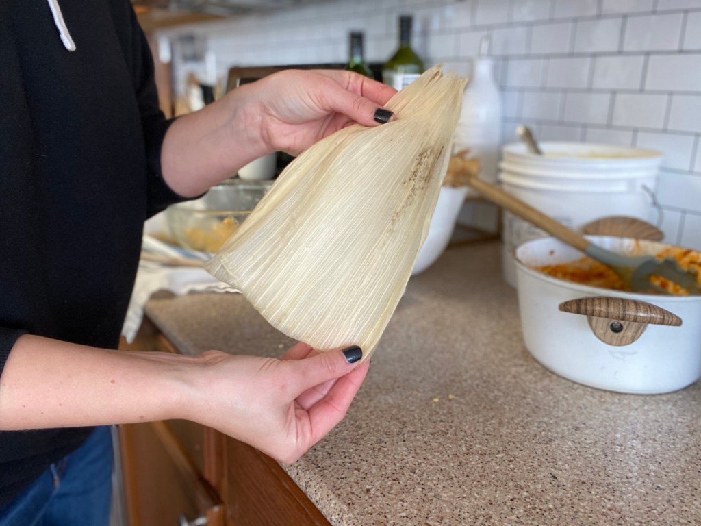 girl holding corn husks