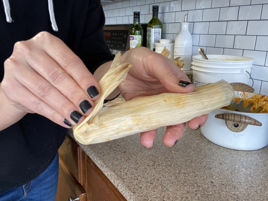 girl folding end of keto tamale