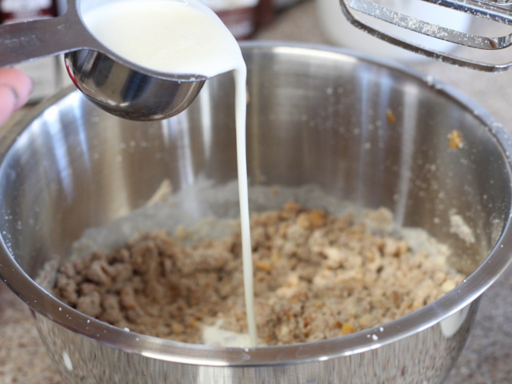 adding heavy cream to mixing bowl