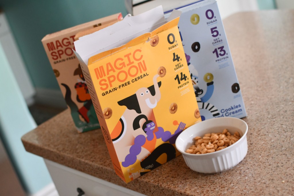 three cereal boxes and a bowl 