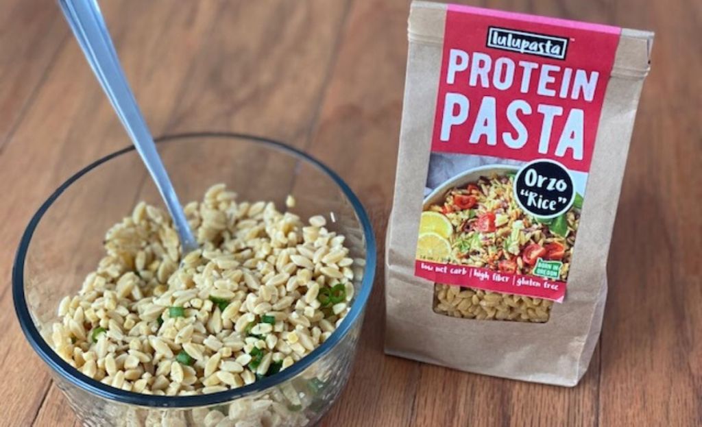 A bowl of Orzo next to the package on a counter