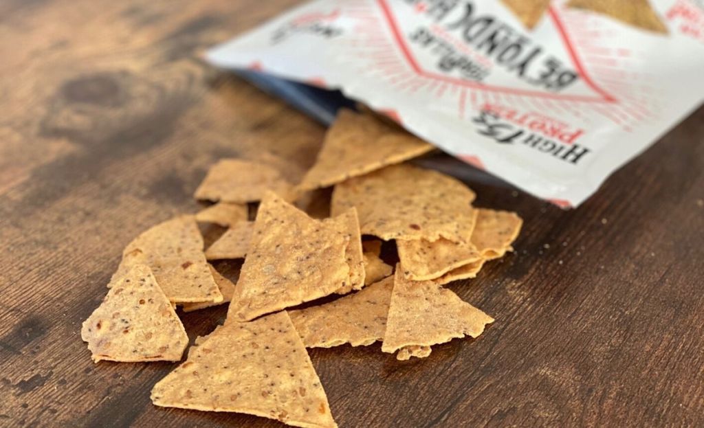 Keto chips spilling out of the bag on a table