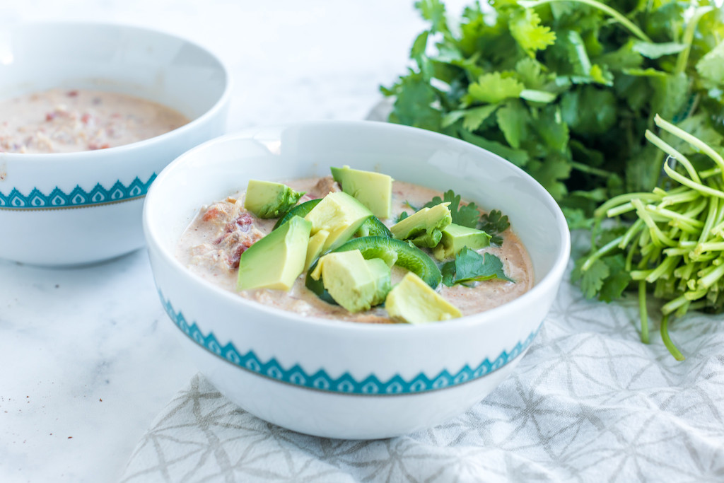 keto white chicken chili in bowl with avocados 