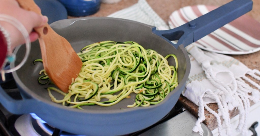 a frying pan with zucchini noodles 