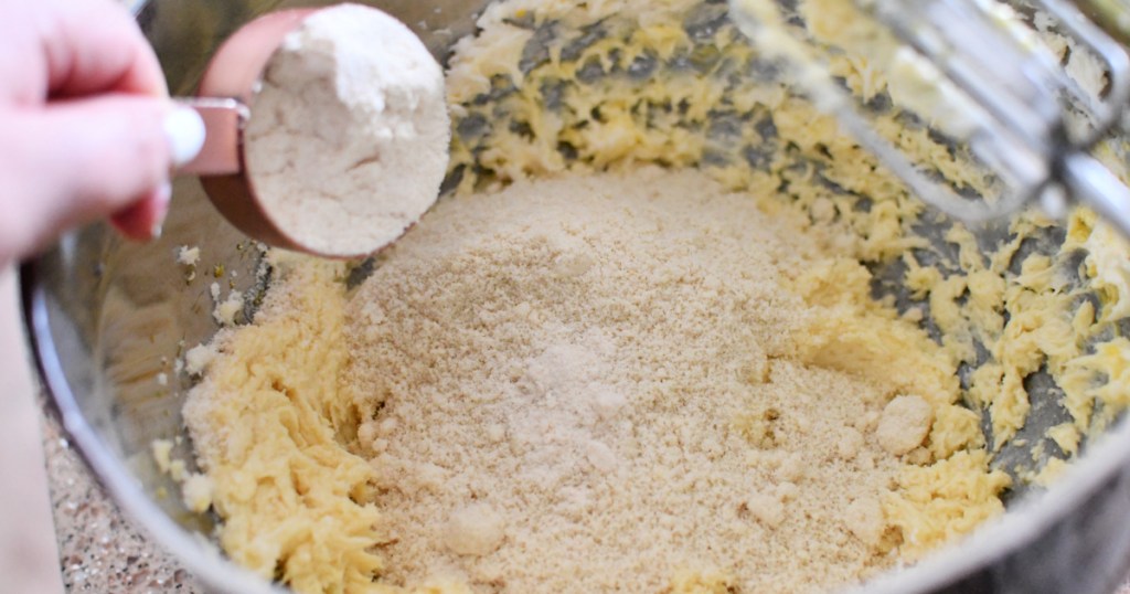 adding almond flour to keto sugar cookie dough 