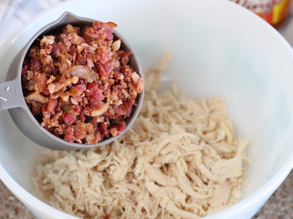 adding bacon crumbles to mixing bowl