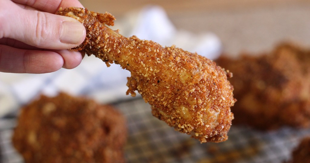 hand holding keto fried chicken drumstick