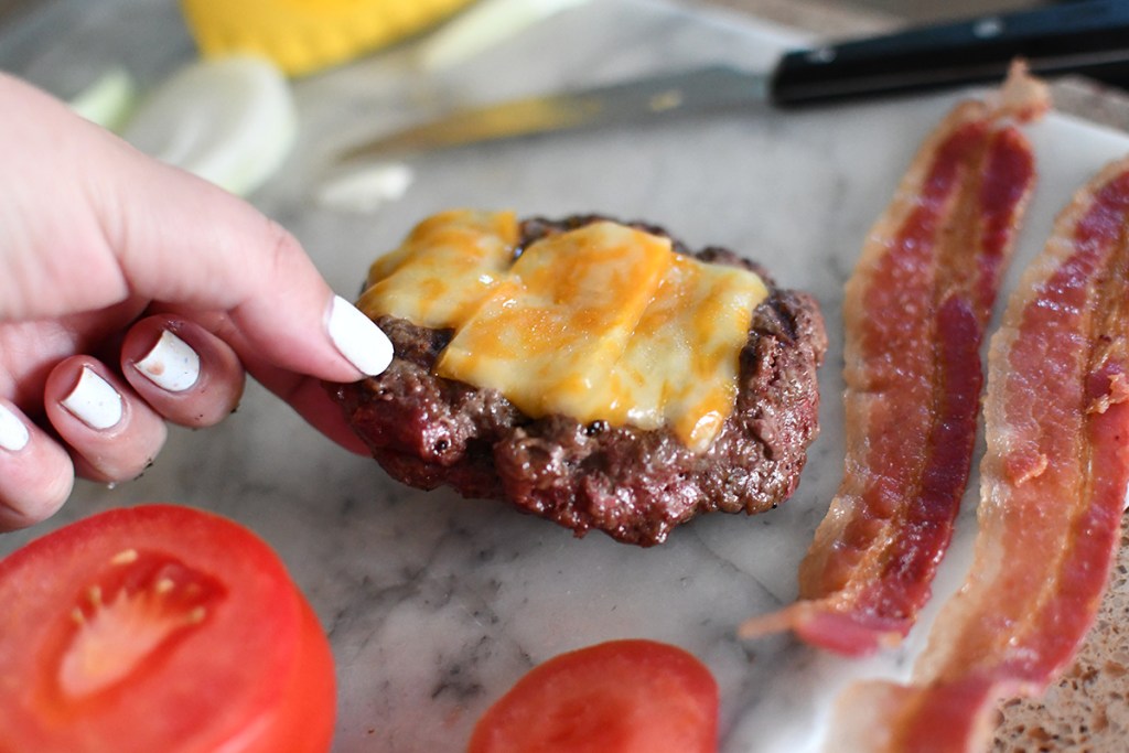 honest bison cooked burger patty with cheese