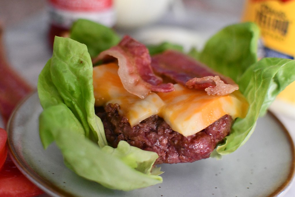 burger on top of lettuce wrap with cheese