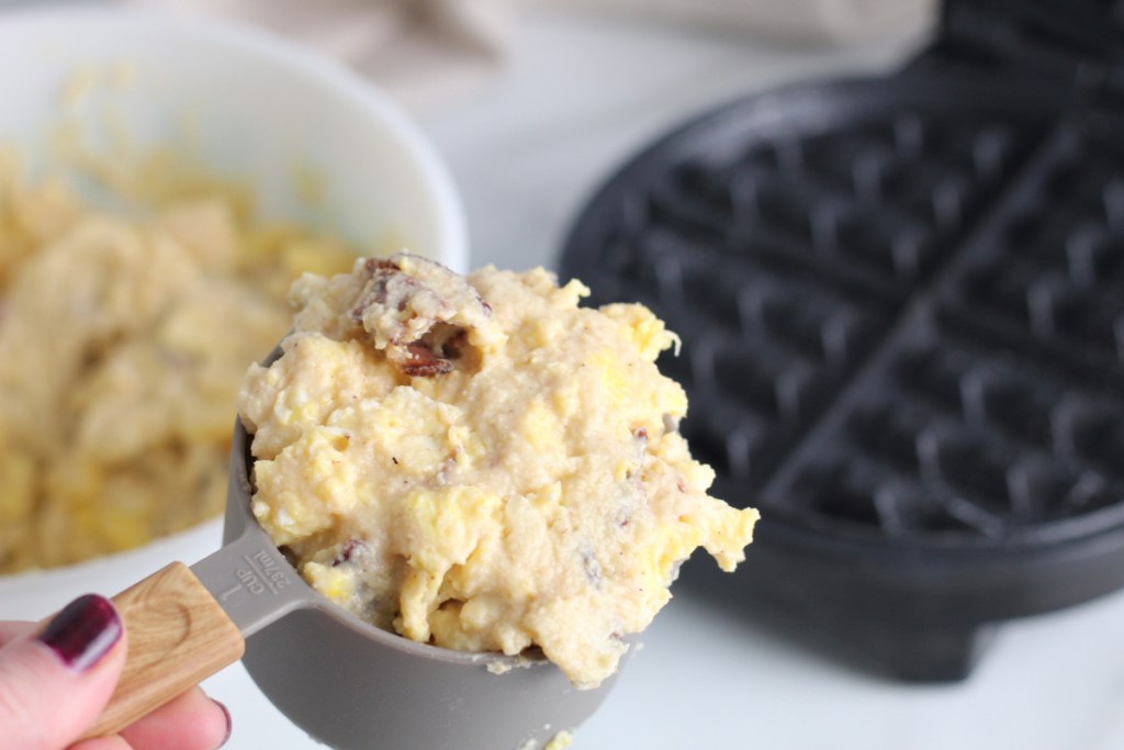 adding batter to waffle maker