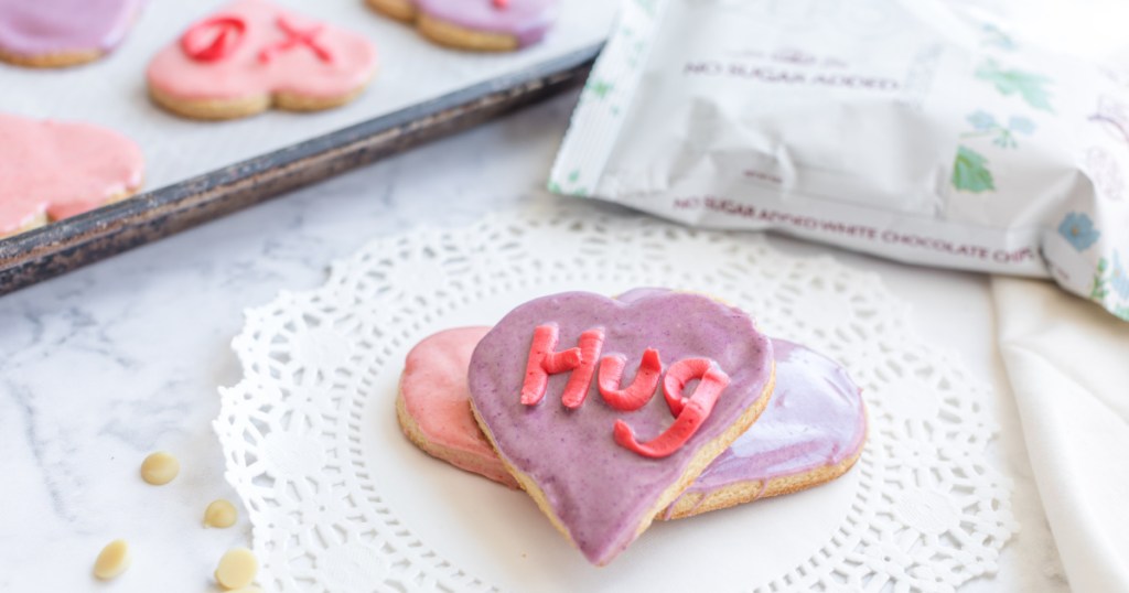 keto conversation heart sugar cookies on a plate next to tray