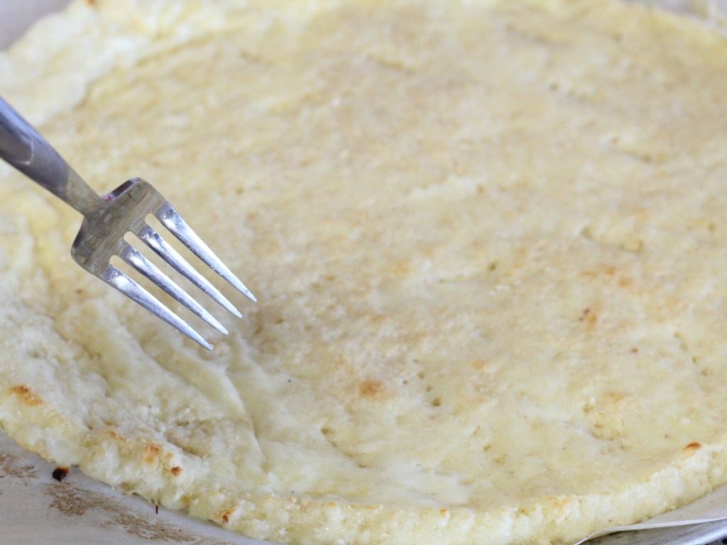 using a fork to create holes in dough