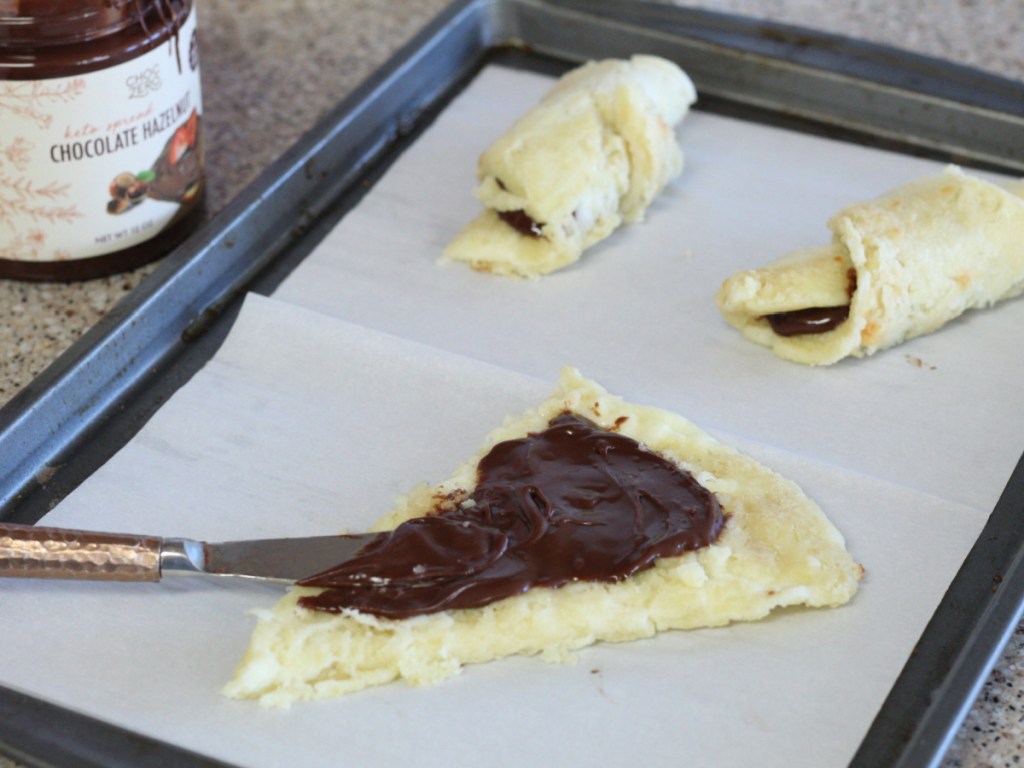 spreading ChocZero chocolate spread on dough