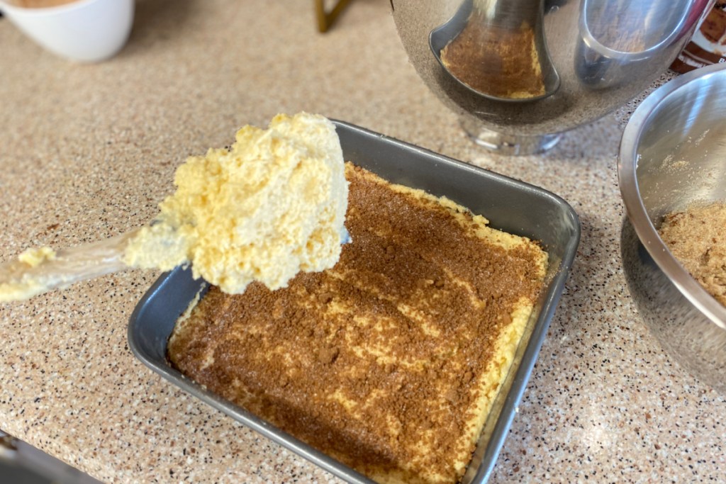 adding cake batter to pan