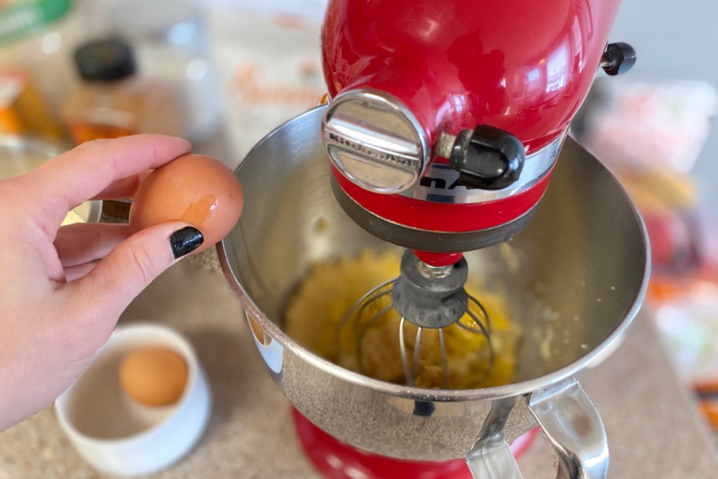 adding eggs to batter in mixer