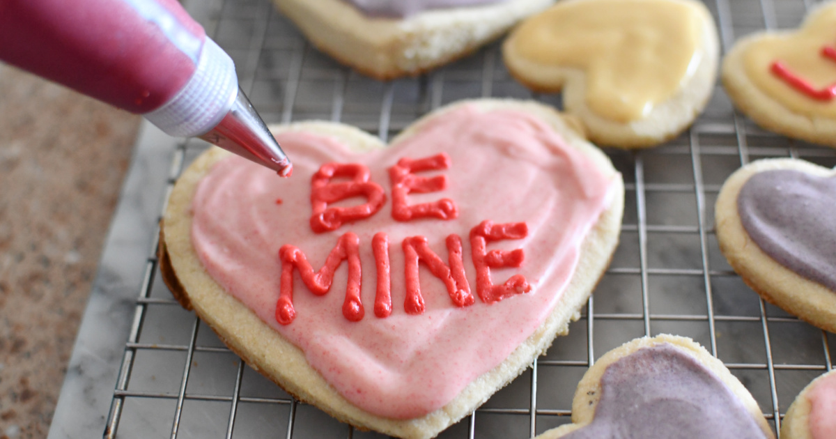 piping be mine onto low carb keto conversation heart cookies