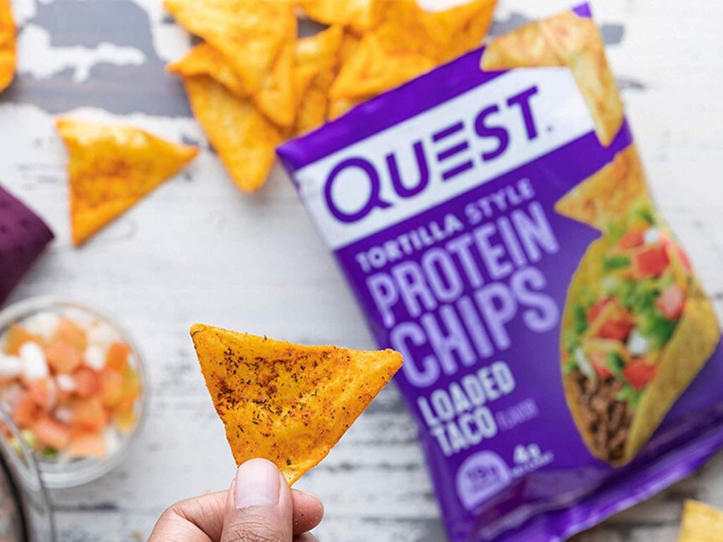 holding a Quest Loaded Taco chip