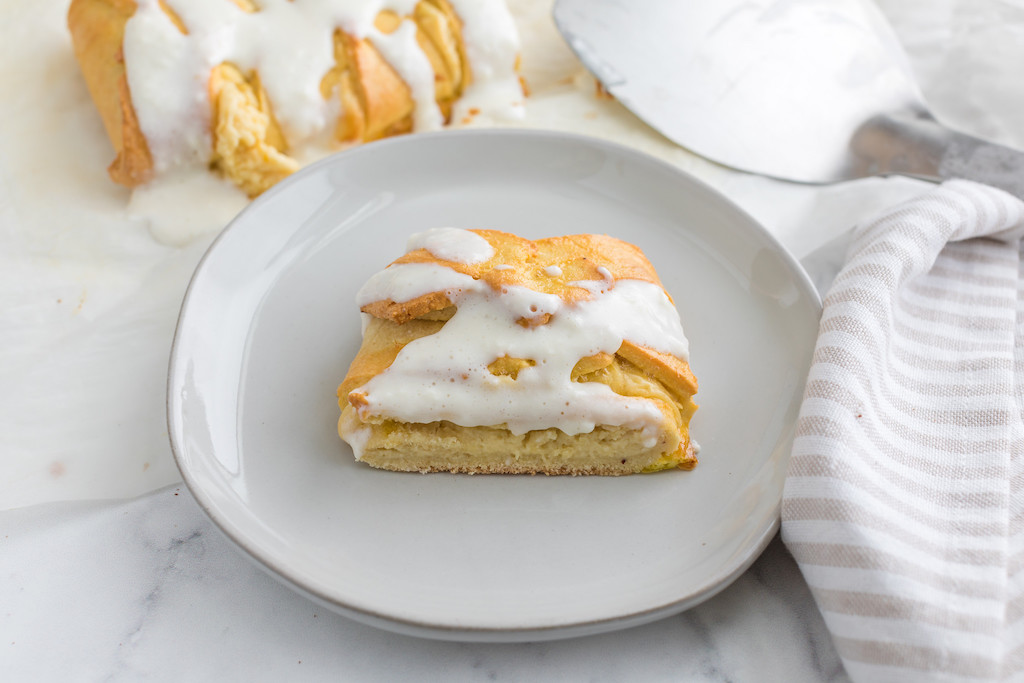 slice of keto cheese danish on plate with frosting