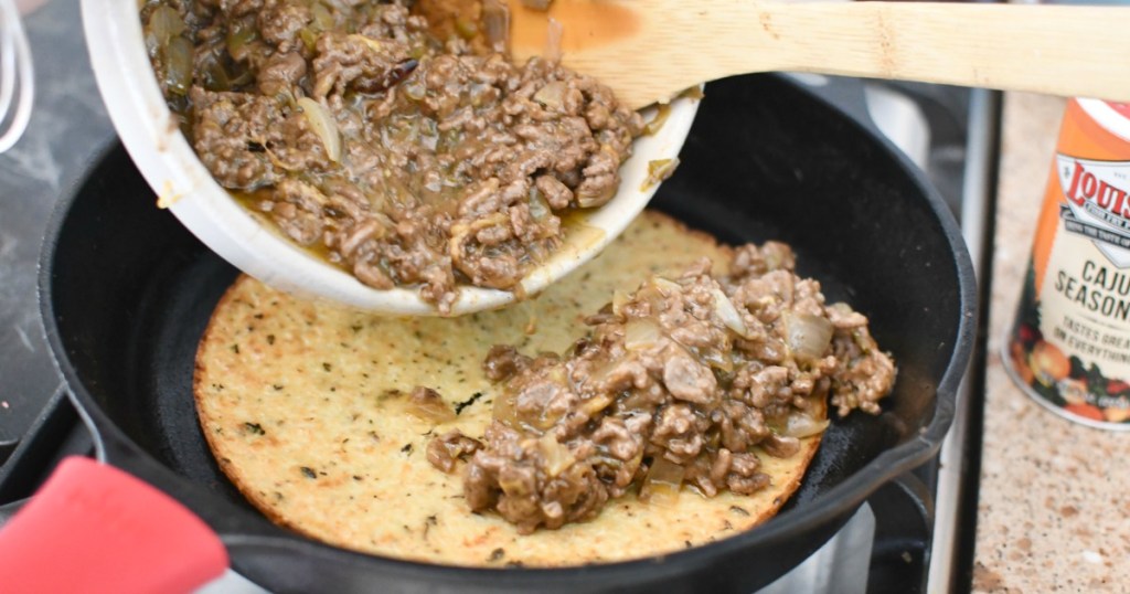 topping keto crust with ground beef mixture