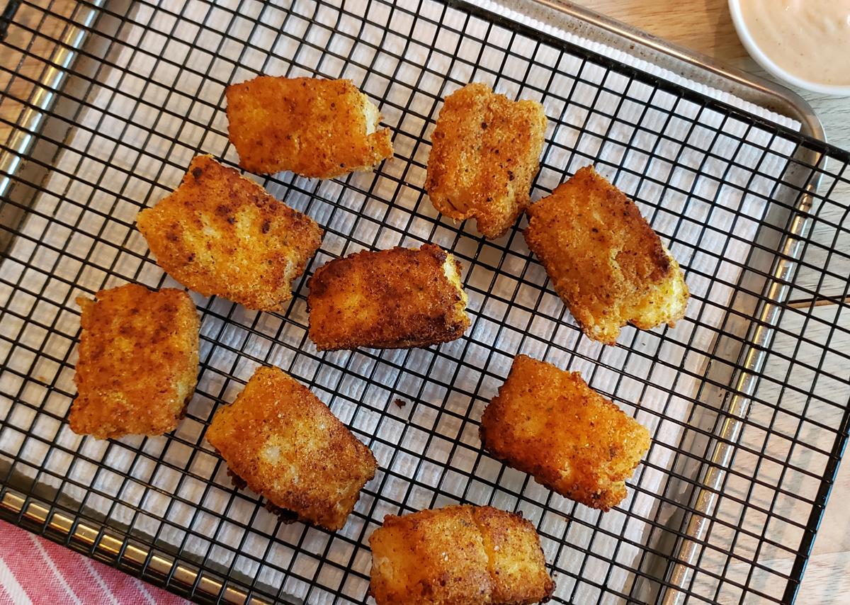 Fish out of the frying pan onto a wire rack