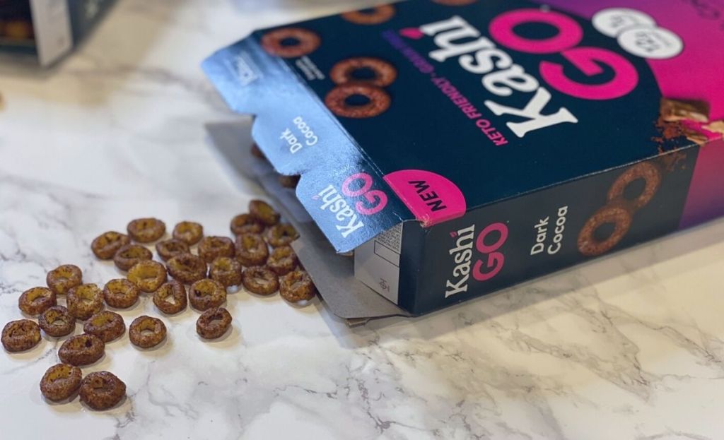 A box of kashi keto cereal with some spilling out on a counter