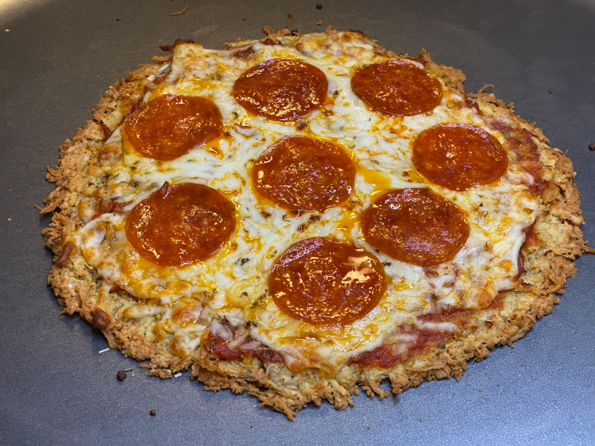 a pepperoni pizza with a low carb crust made of chicken breast