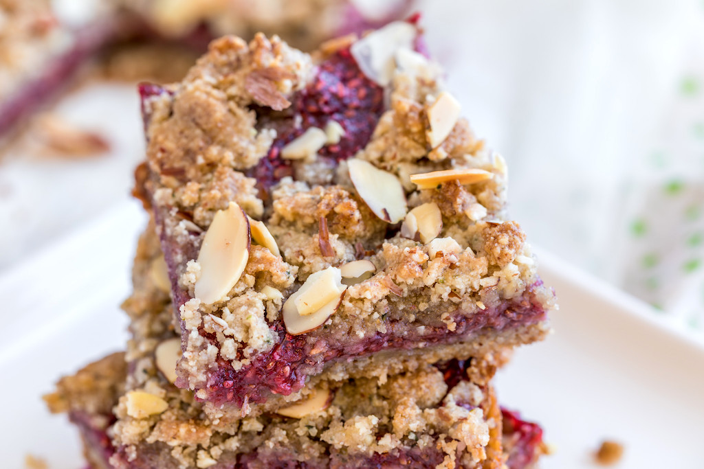 keto raspberry bars stacked on plate 