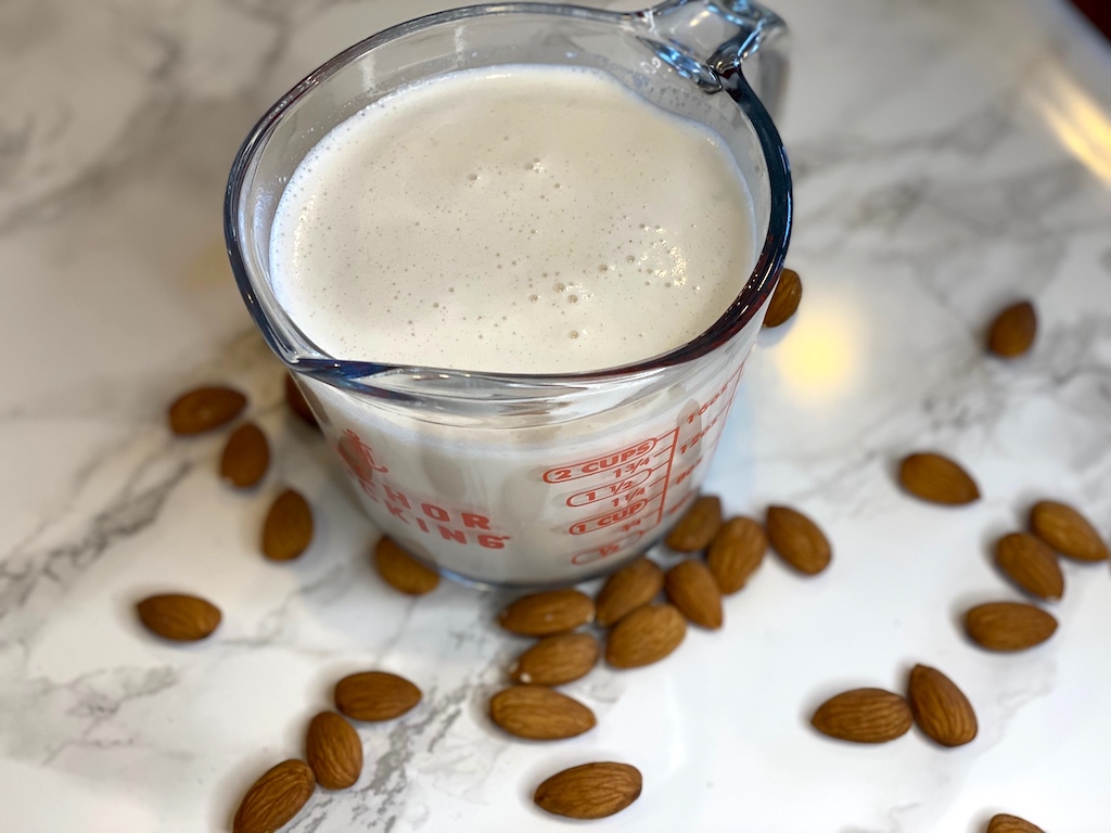 almond milk in measuring cup 