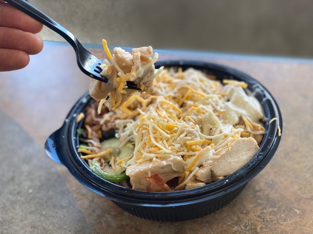 fork holding bite over chicken bacon ranch bowl
