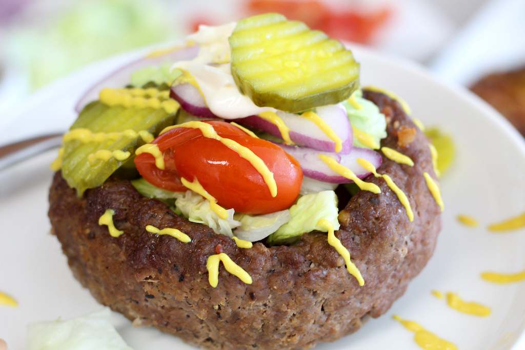 keto burger in a bowl filled with toppings 