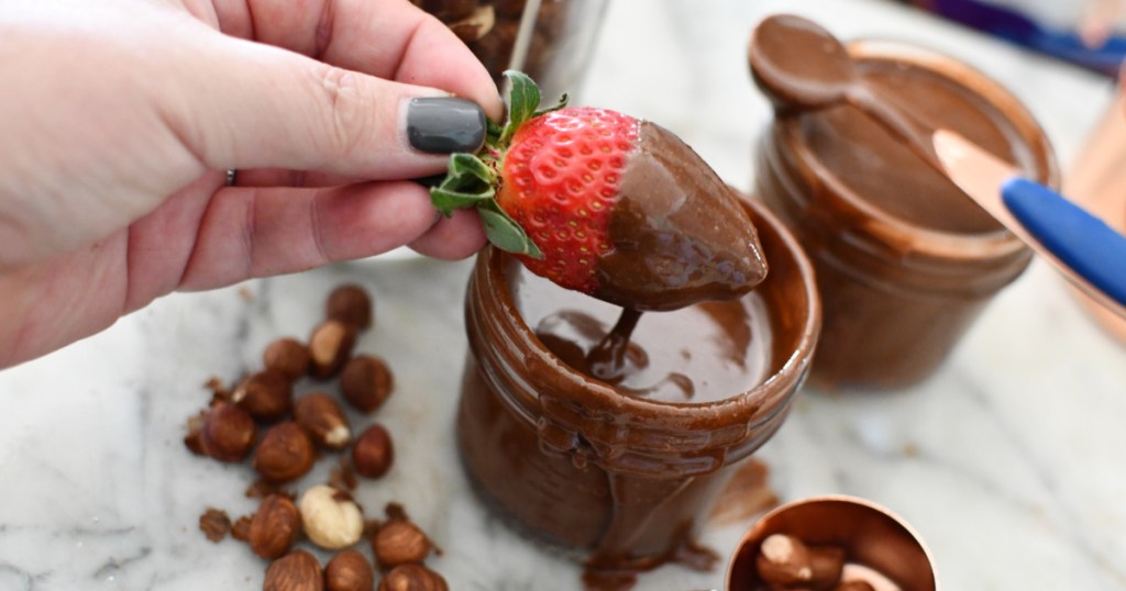 dipping a strawberry in Nutella