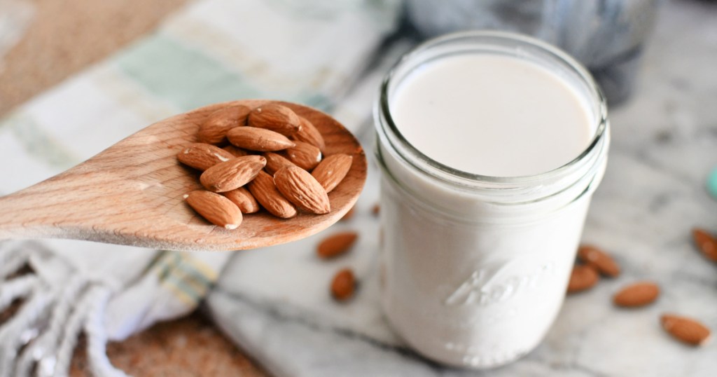 jar of homemade keto almond milk next to almonds