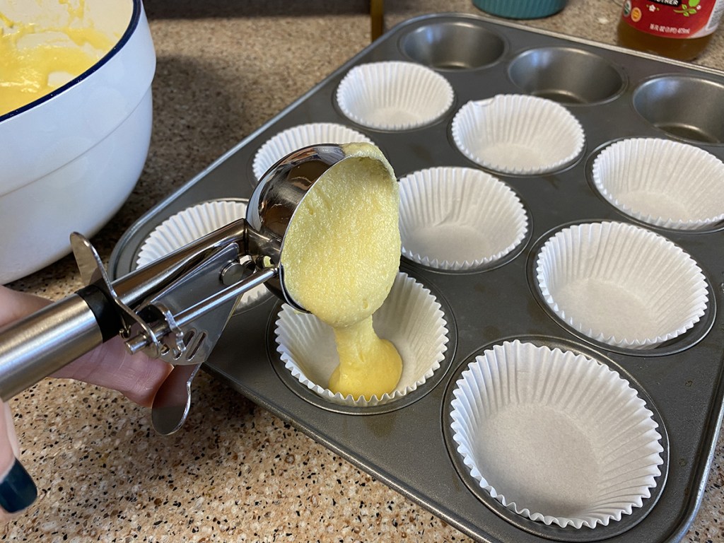 adding keto baking mix batter into muffin tin