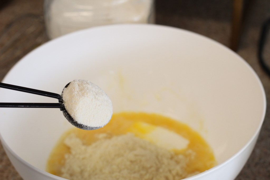 adding coconut flour to mixing bowl