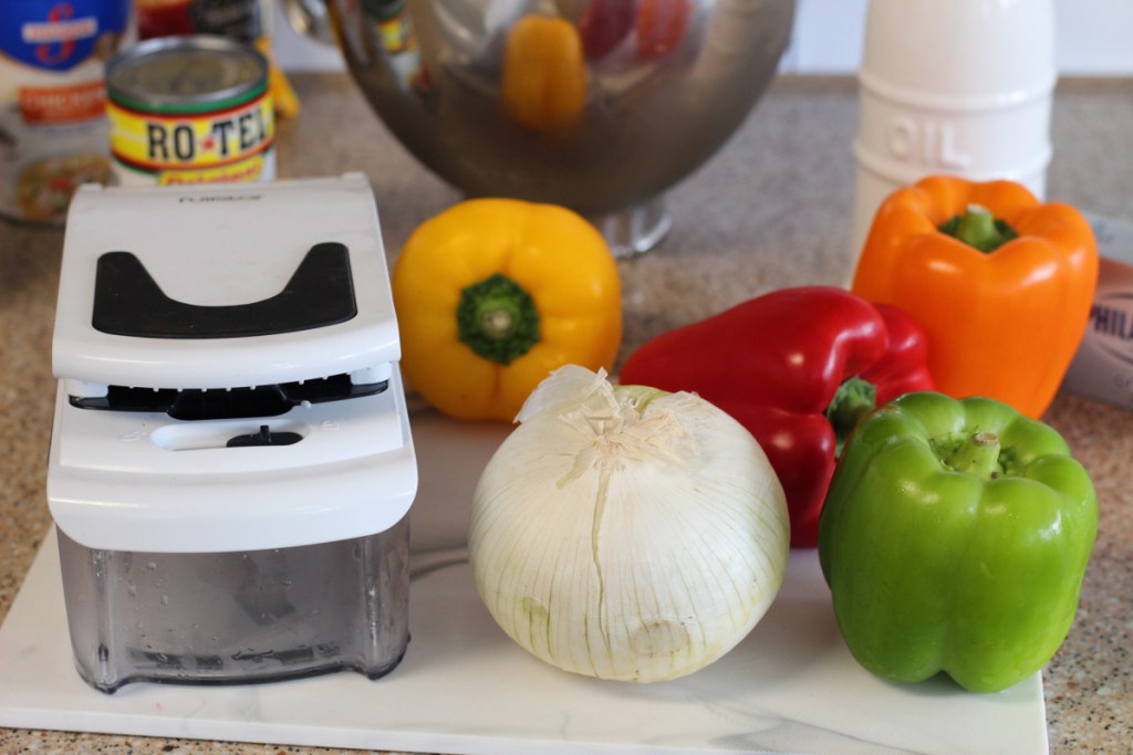 peppers and food chopper on cutting board