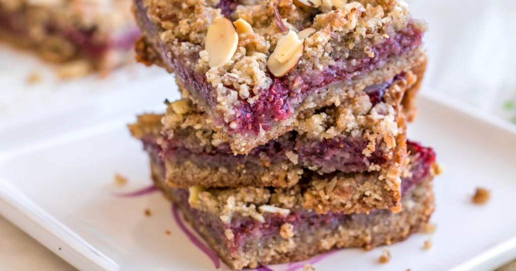 keto raspberry bars stacked up 