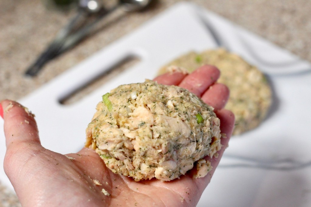 creating a salmon patty in hand