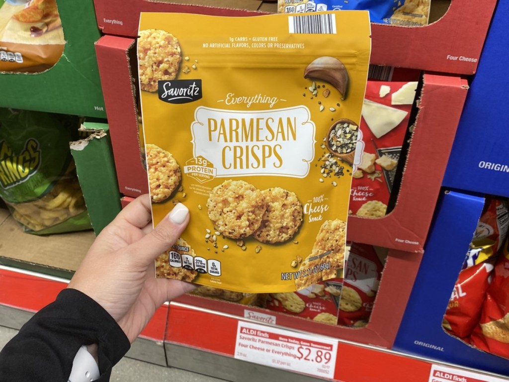 holding bag of parmesean crisps