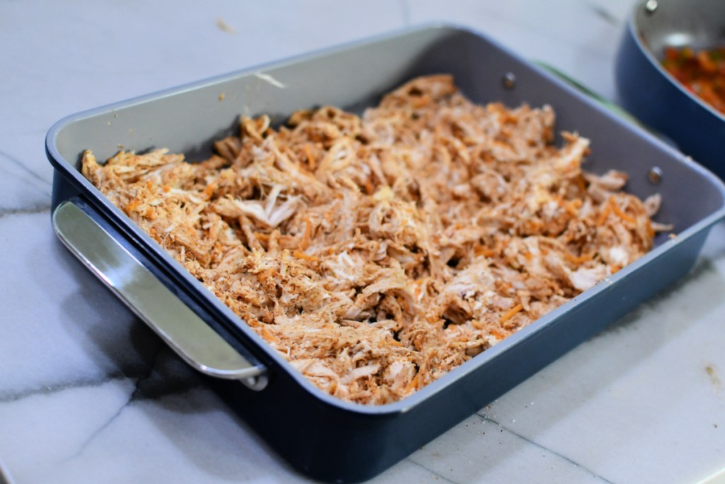 seasoned shredded chicken in a casserole dish